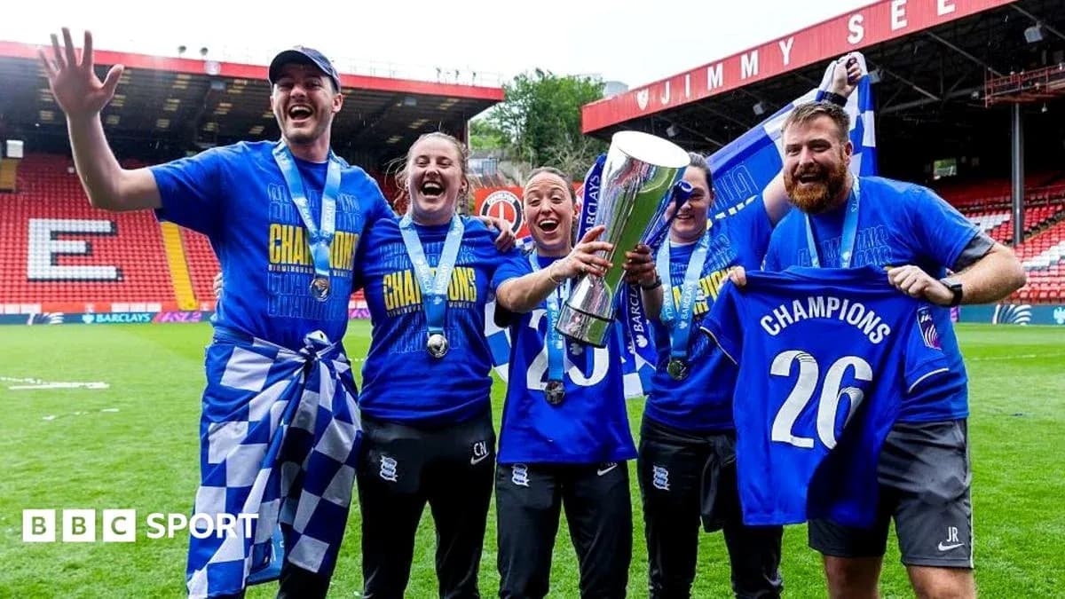 Celebrating team with trophy and champion shirts