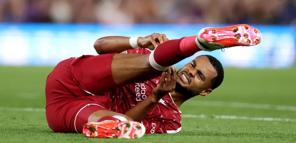 Player lying on ground clutching injured leg