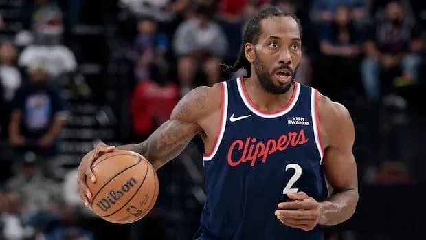 Player dribbling basketball during game action Player dribbling basketball during game action