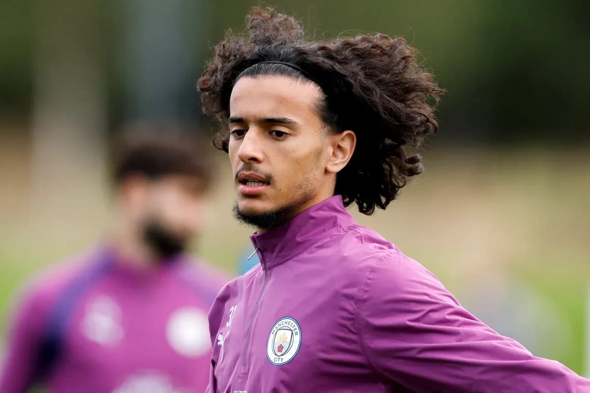 Player training in Manchester City kit on field Player training in Manchester City kit on field