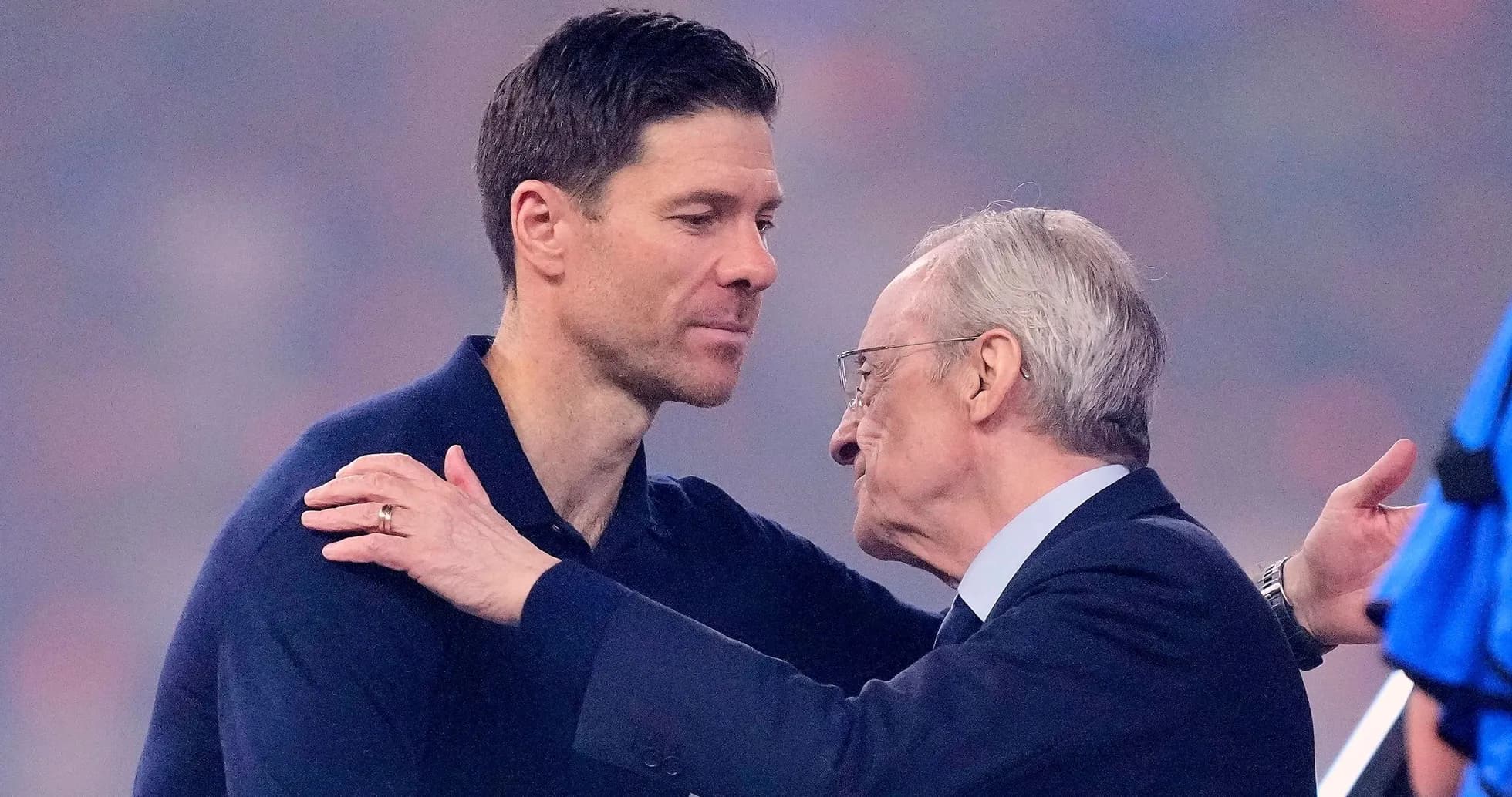 Two men embracing during a formal event Two men embracing during a formal event