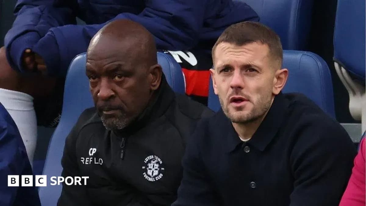 Two men seated on sidelines during a match Two men seated on sidelines during a match