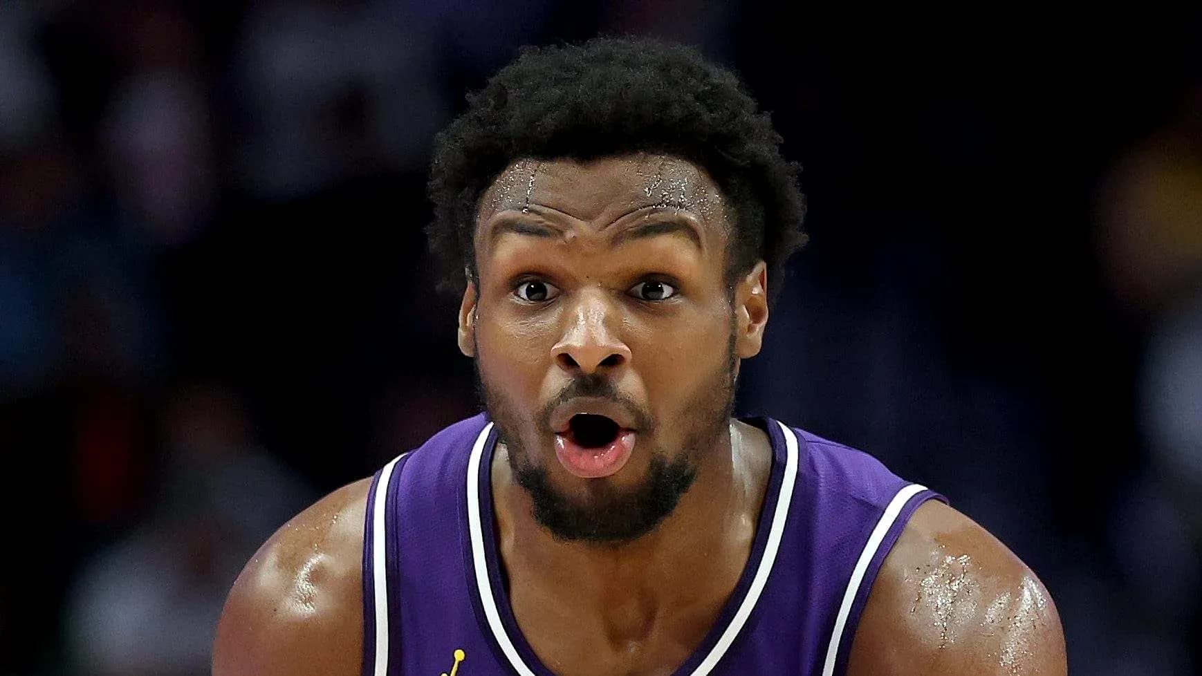 Basketball player in purple jersey during game Basketball player in purple jersey during game
