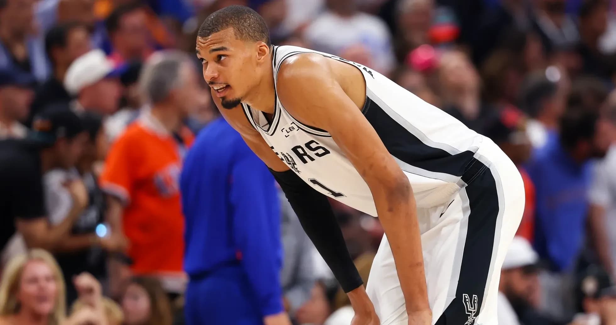 Player in Spurs jersey during basketball game Player in Spurs jersey during basketball game