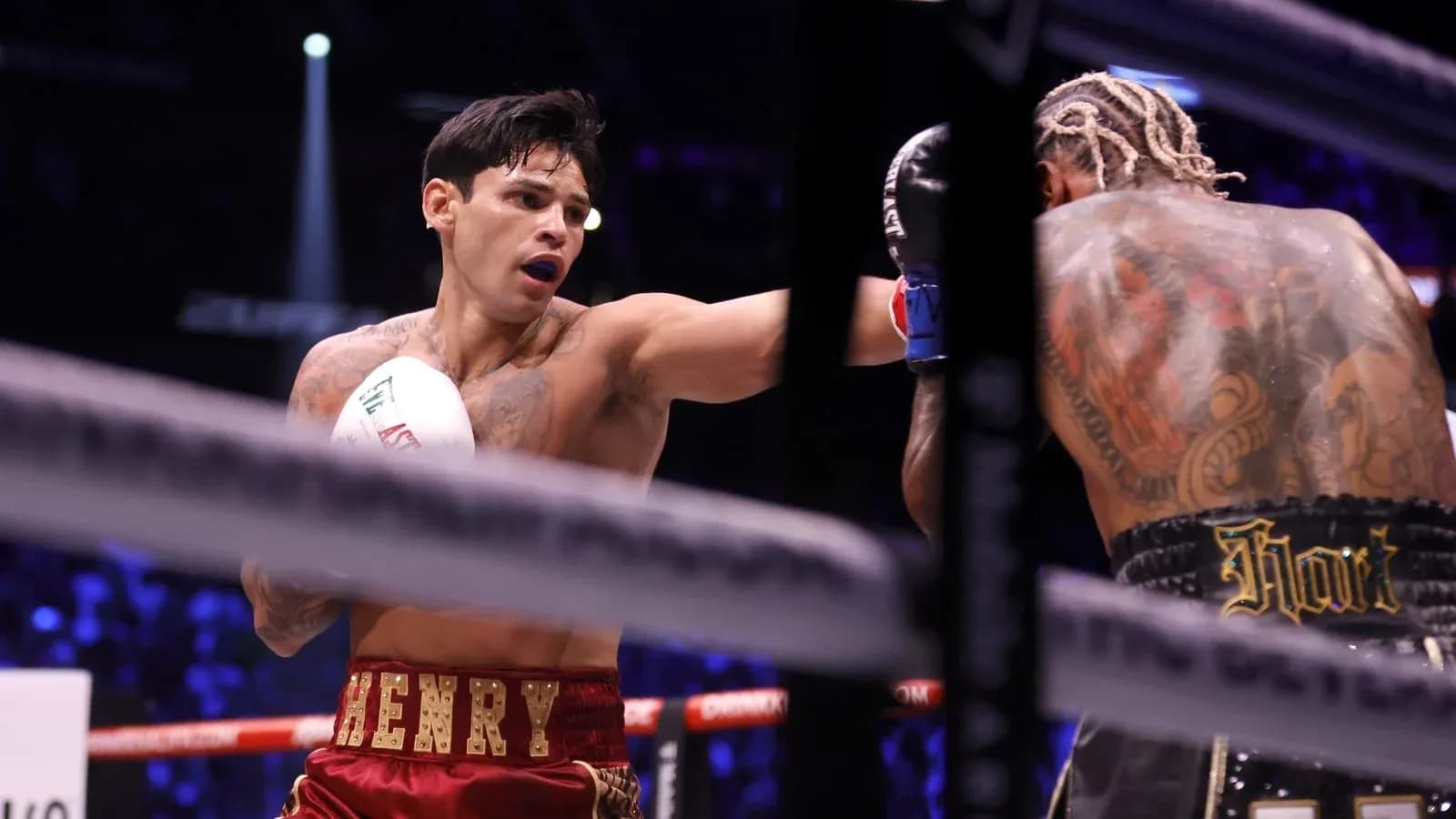 Boxer throwing a punch during a match Boxer throwing a punch during a match