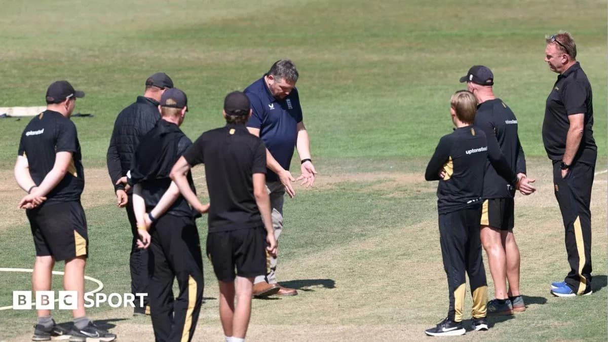Coaching staff discussing strategy on cricket field Coaching staff discussing strategy on cricket field
