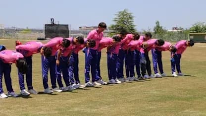 Cricket team bowing during a training session Cricket team bowing during a training session