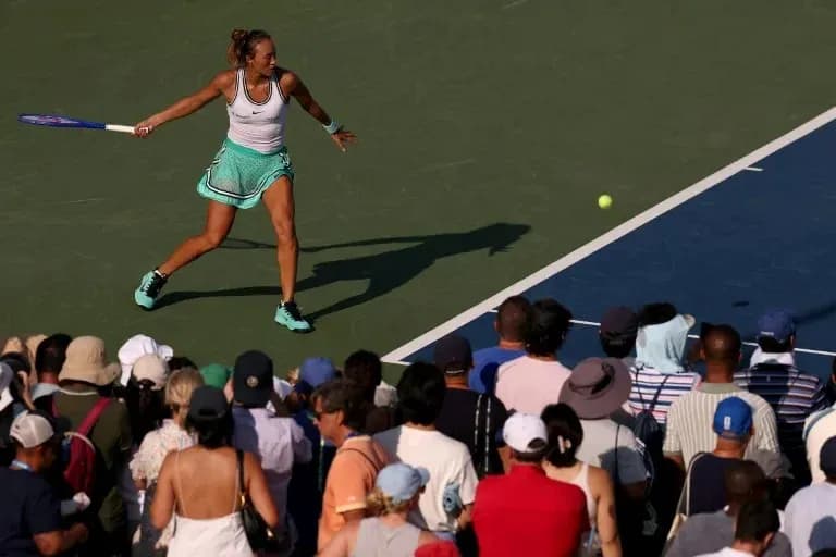 Tennis player hitting a forehand shot during match Tennis player hitting a forehand shot during match