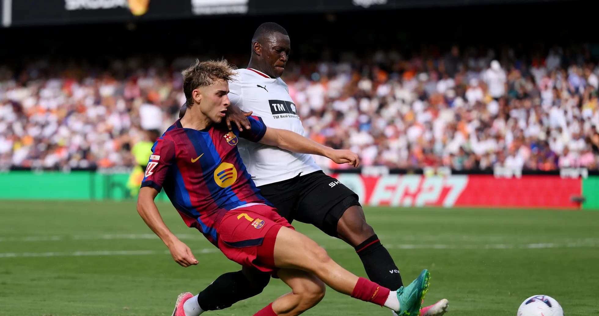 Barcelona player tackling opponent during match action Barcelona player tackling opponent during match action