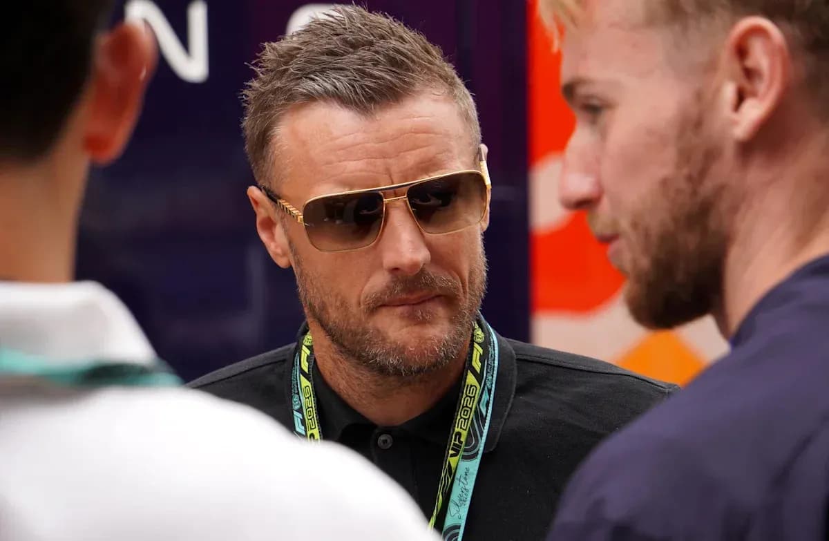 Man wearing sunglasses talking with two others Man wearing sunglasses talking with two others