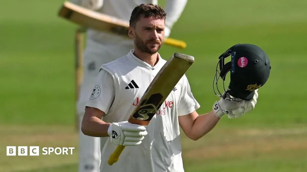 Batsman raising bat and helmet after scoring Batsman raising bat and helmet after scoring
