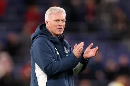 Manager clapping during a match on the sidelines Manager clapping during a match on the sidelines