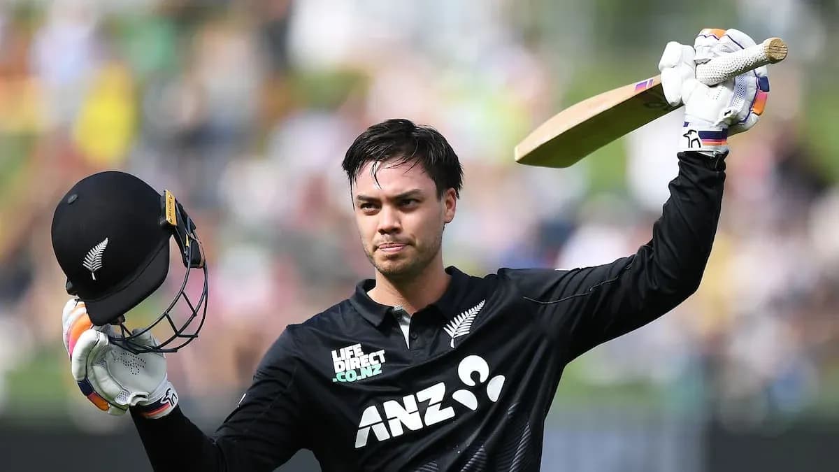 Cricketer celebrating with bat and helmet raised Cricketer celebrating with bat and helmet raised