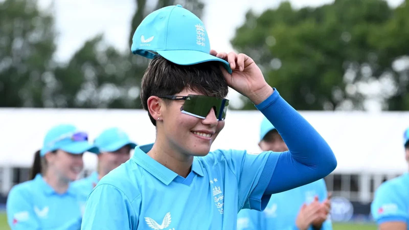 Cricketer adjusting cap during team event Cricketer adjusting cap during team event