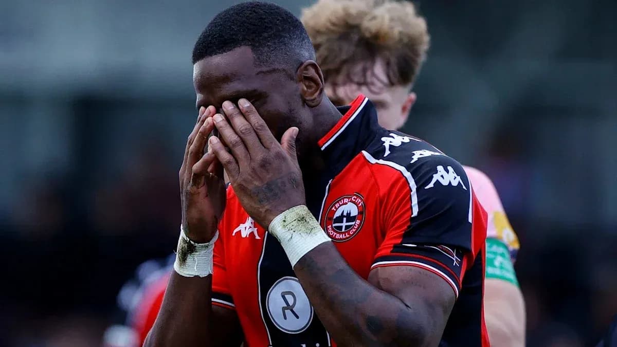 Player holding his face in disappointment on the field Player holding his face in disappointment on the field