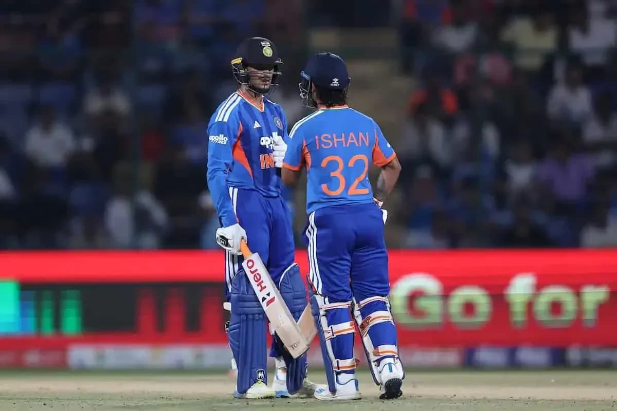 Two cricket players discussing strategy on field Two cricket players discussing strategy on field