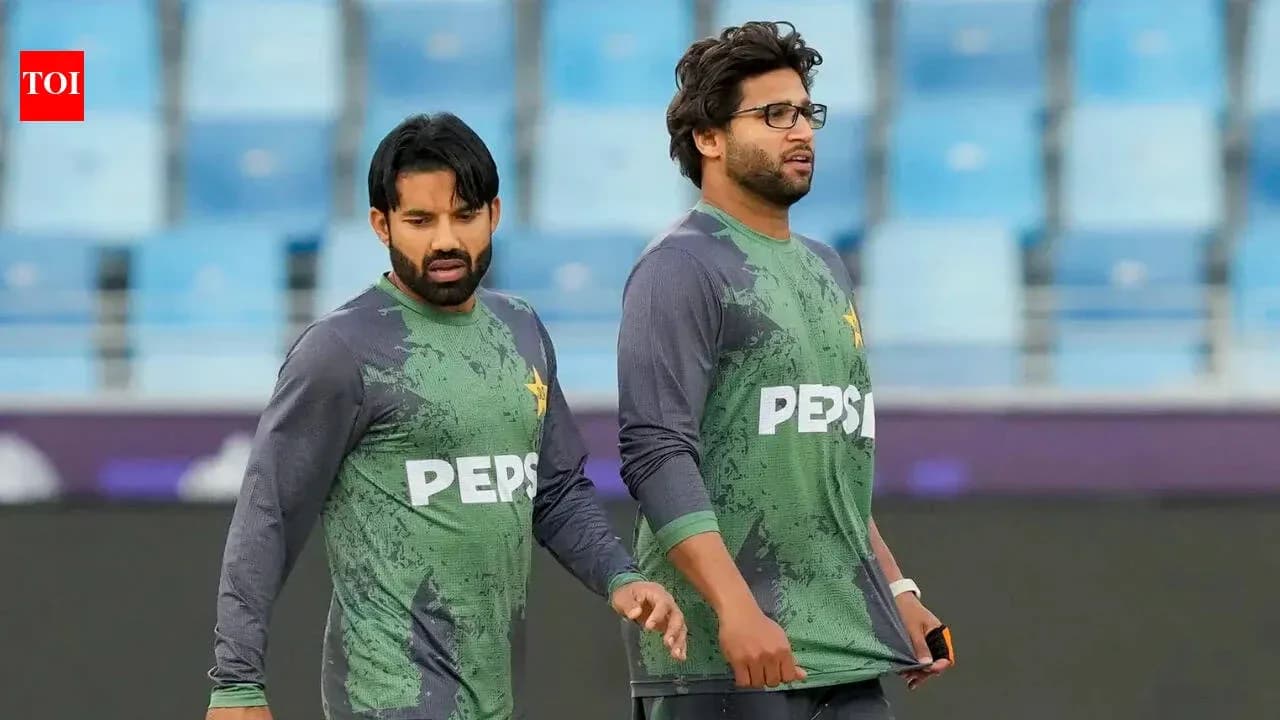 Two Pakistan cricket players walking on field Two Pakistan cricket players walking on field