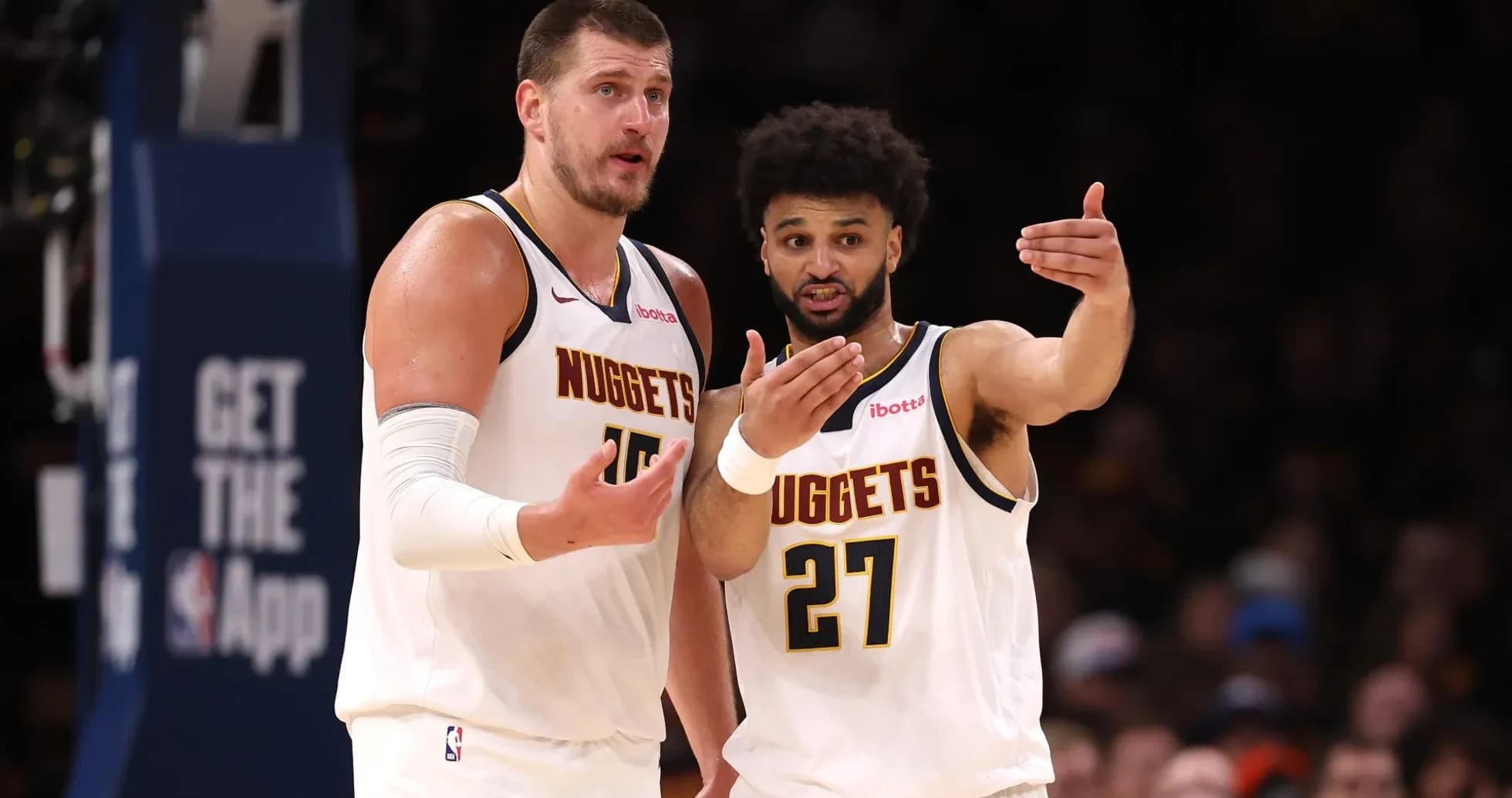 Two Denver Nuggets players discussing during a game Two Denver Nuggets players discussing during a game