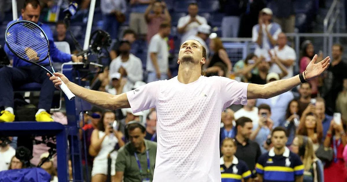 Player celebrating victory with arms raised on court Player celebrating victory with arms raised on court