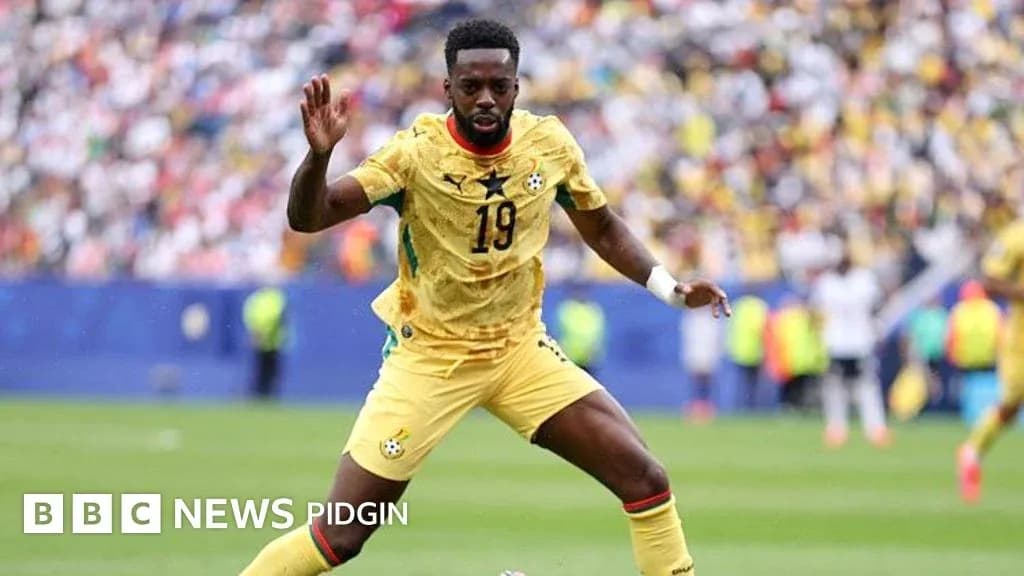 Ghana player in yellow jersey during match action Ghana player in yellow jersey during match action