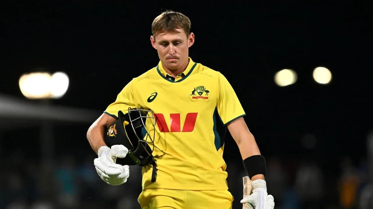 Australian cricketer walking off field after dismissal Australian cricketer walking off field after dismissal