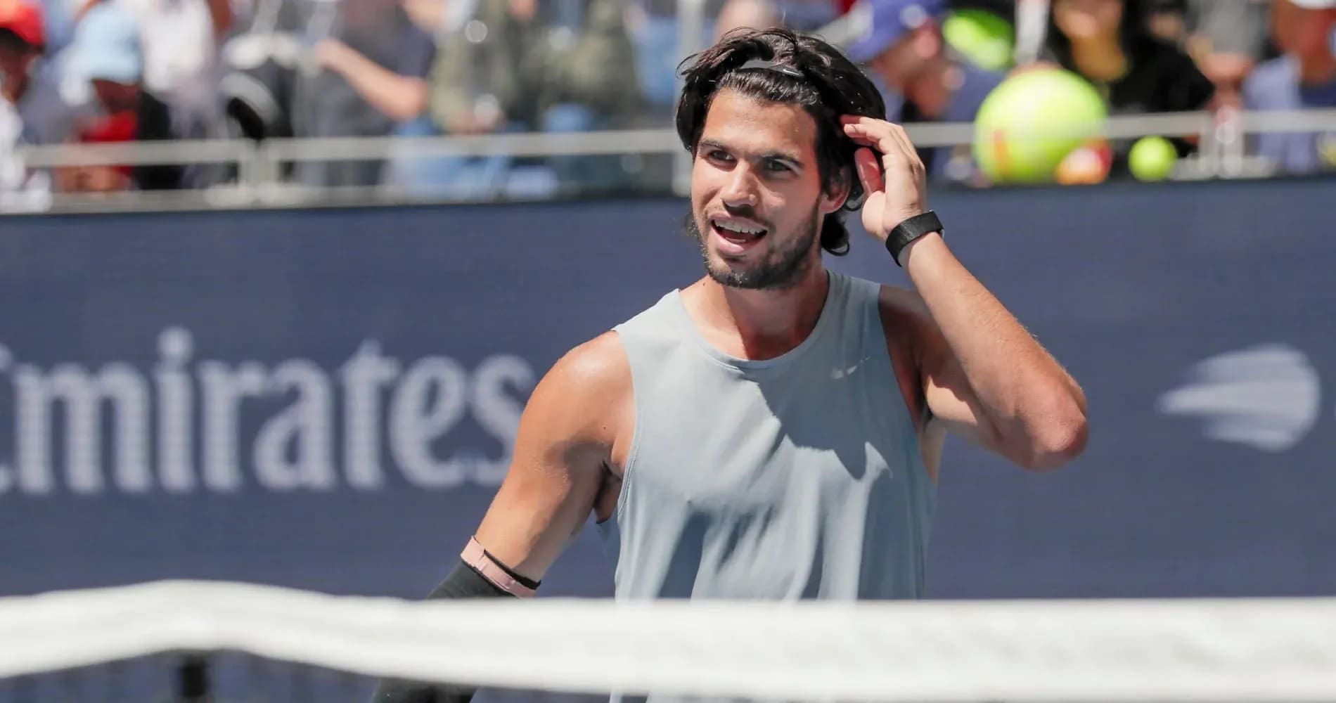 Tennis player adjusting hair during match Tennis player adjusting hair during match