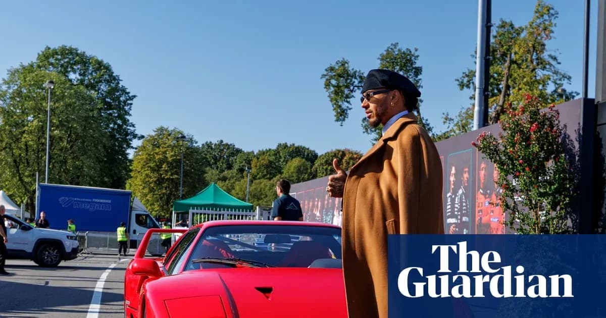 Person beside a red sports car at event Person beside a red sports car at event