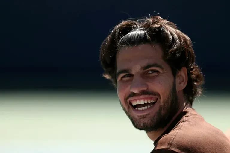 Tennis player smiling during practice session Tennis player smiling during practice session