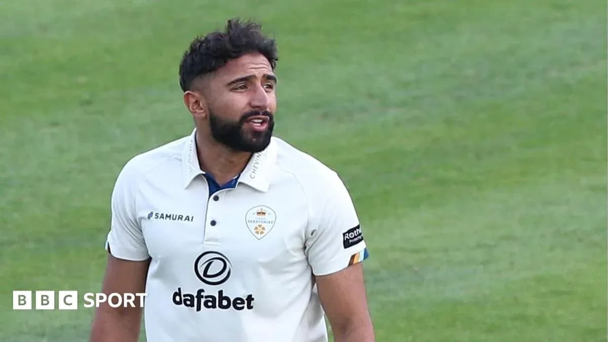 Cricketer in Derbyshire kit on the field Cricketer in Derbyshire kit on the field
