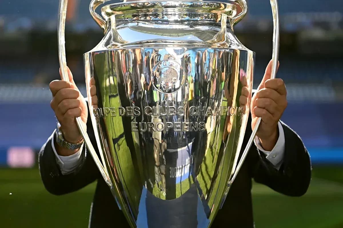 Champions League trophy held by an individual Champions League trophy held by an individual