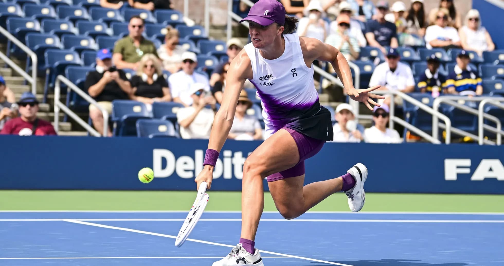 Player reaching for a tennis ball on court Player reaching for a tennis ball on court
