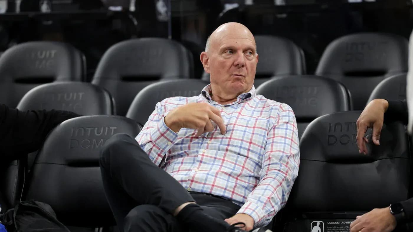 Man sitting in arena seats during a game Man sitting in arena seats during a game