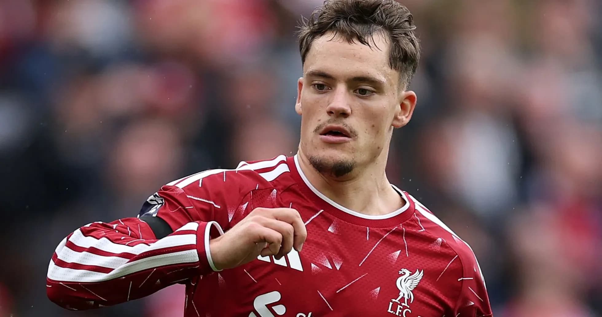 Player in Liverpool kit gesturing on the field Player in Liverpool kit gesturing on the field