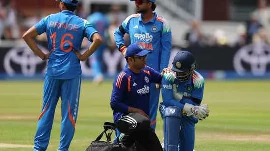 Cricket players during injury timeout on field Cricket players during injury timeout on field