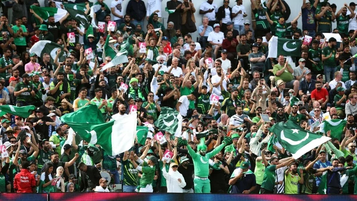 Crowd of fans cheering with Pakistan flags in stadium Crowd of fans cheering with Pakistan flags in stadium