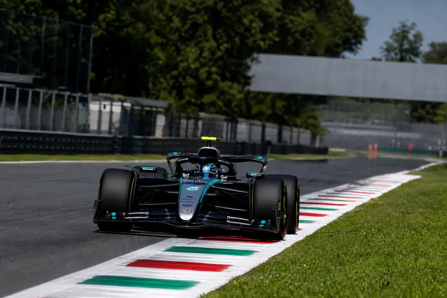 Formula 1 car navigating a curve on track Formula 1 car navigating a curve on track