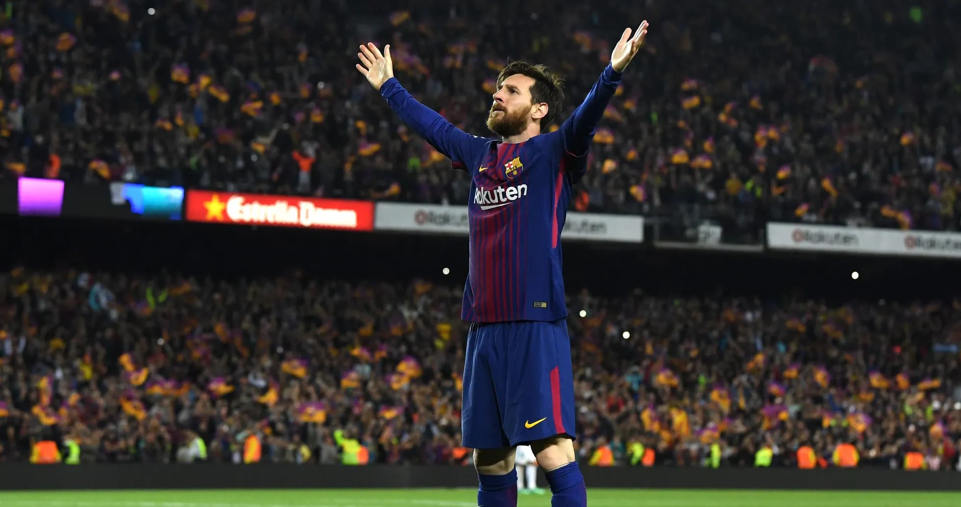 Player celebrating with arms raised in stadium Player celebrating with arms raised in stadium