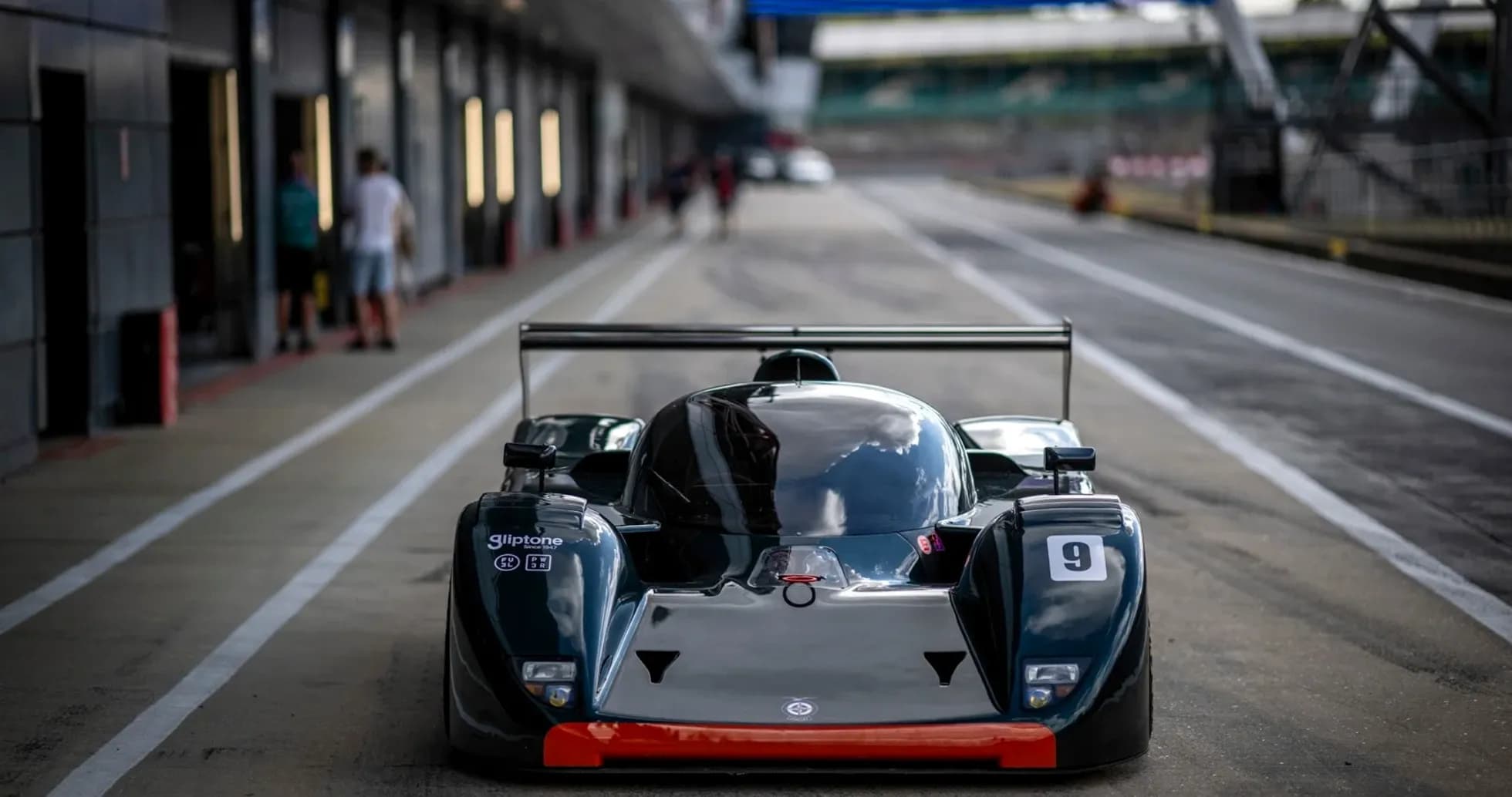 Racing car in pit lane at racetrack Racing car in pit lane at racetrack