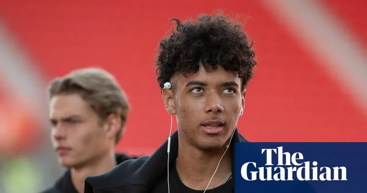 Two young men walking, one wearing headphones Two young men walking, one wearing headphones