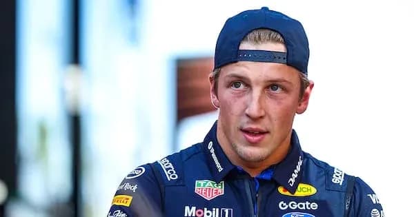 Racing driver wearing team uniform and cap Racing driver wearing team uniform and cap