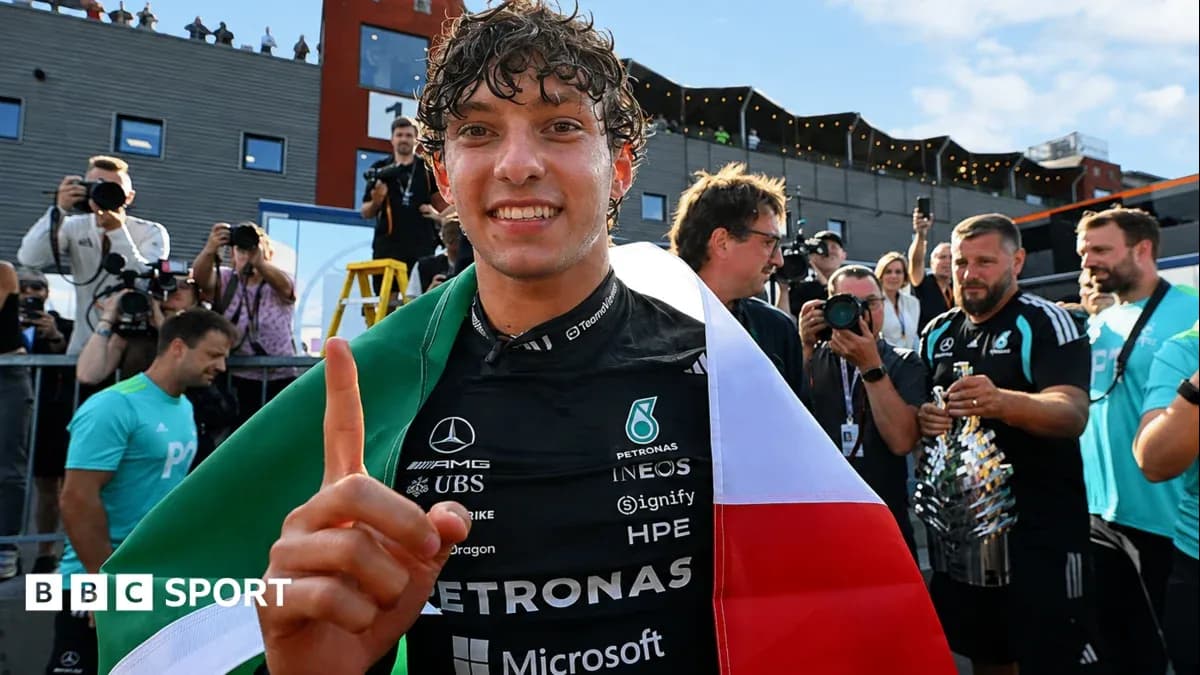 Driver celebrating with flags after race victory Driver celebrating with flags after race victory