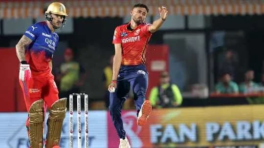 Bowler delivering a ball while batsman prepares to bat Bowler delivering a ball while batsman prepares to bat
