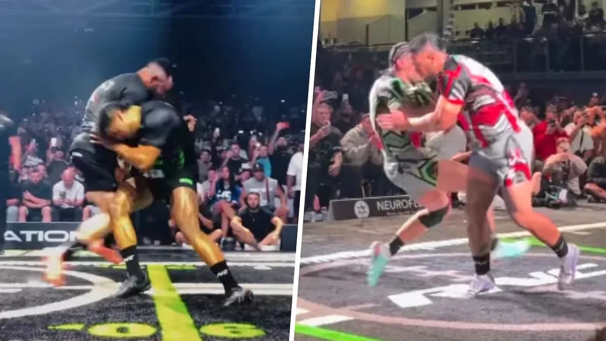 Two wrestlers grappling in front of a cheering crowd Two wrestlers grappling in front of a cheering crowd