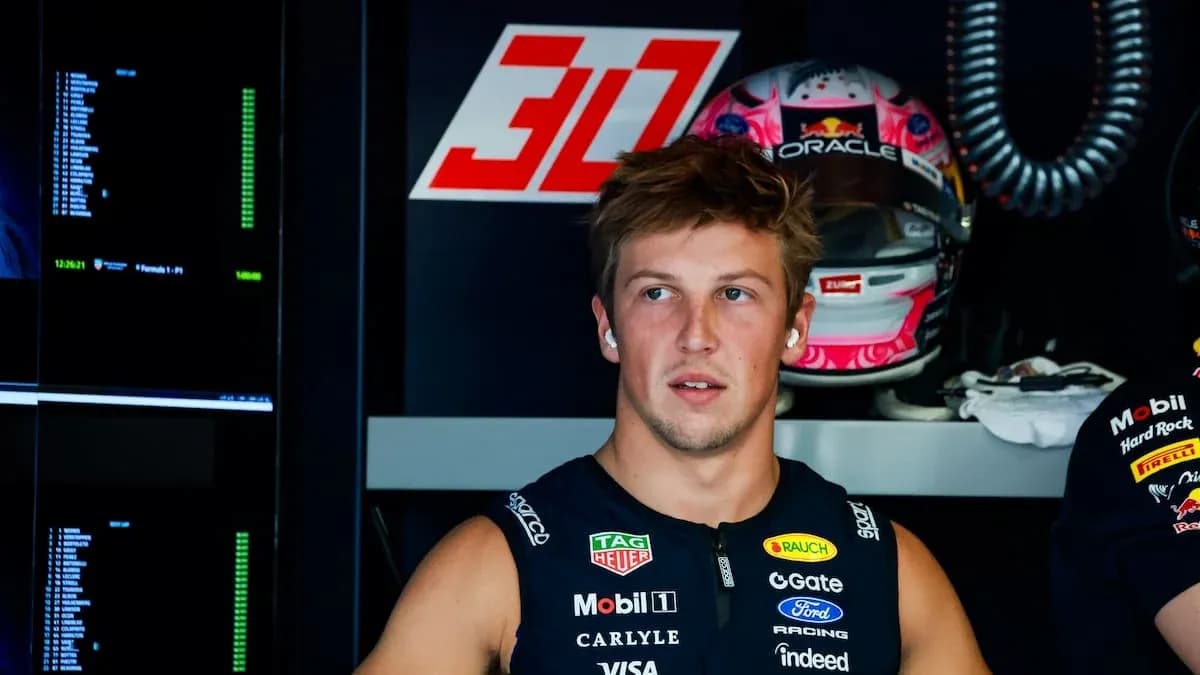 Driver in garage with racing gear and helmet Driver in garage with racing gear and helmet