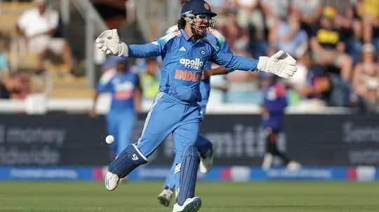 Wicketkeeper diving to catch a cricket ball Wicketkeeper diving to catch a cricket ball